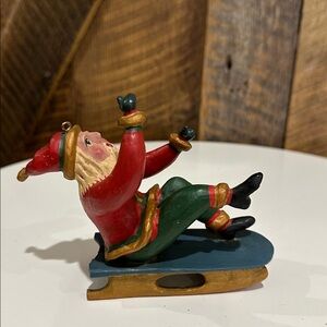 Vintage 1994 Bill Jauquet folk art Santa Claus riding a blue sled ornament